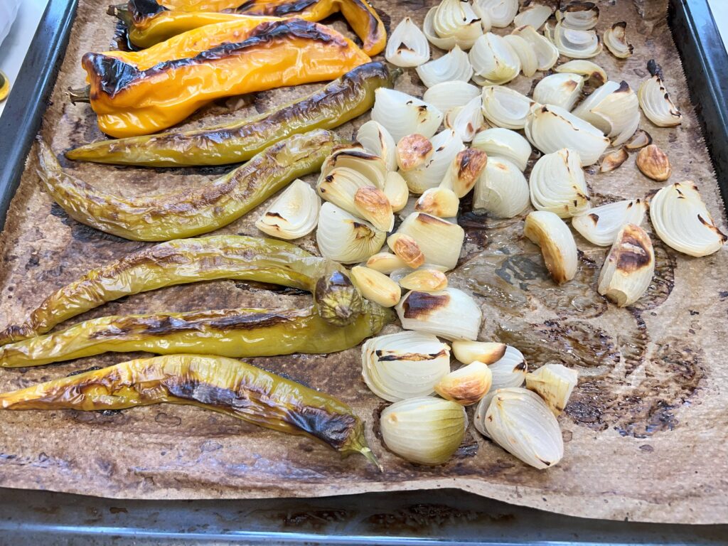 stark gebräunte paprikas, zwiebeln und knoblauch auf backblech