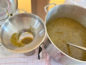 fertige salsa wird mit einem trichter in gläser gefüllt